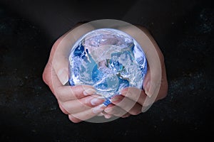 Female hands holding Earth in outer space, concept save the world