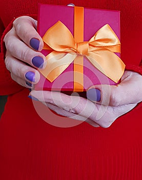 Female hands holding a gift box decoration photo