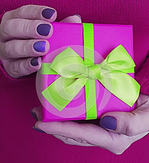 Female hands holding a gift box decoration celebration