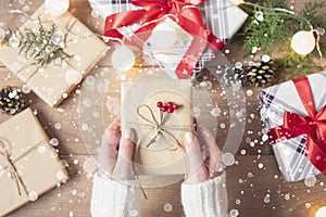 Female Hands Holding Gift Box. Woman Packing Christmas Gifts. Top View, Flat Lay, Advent Gift. Winter Holidays Background. Drawn