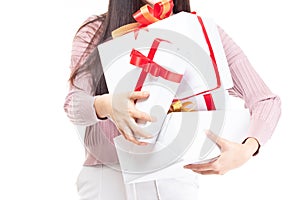 Female hands holding gift box wrapped with red ribbon isolated on white background with copy space. Woman hand holding gift box in