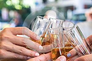 Female hands holding glasses and toasting, celebration, outdoors