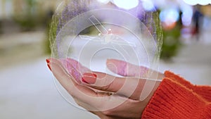 Female hands holding hologram satellite