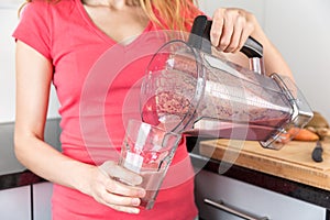 Female hands holding a jar of smoothie