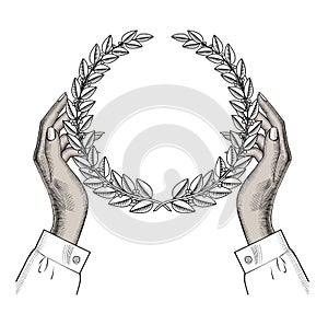 Female hands holding a laurel wreath. Rewarding with a laurel wreath