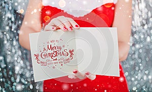 Female hands holding Merry Christmas card or letter to Santa. Xmas and New Year theme.