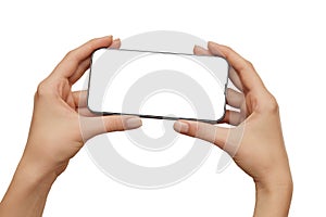 Female hands holding modern mobile phone with blank screen with clipping path isolated at white background. Cellphone mockup