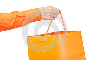 Female hands holding an orange shopping bag