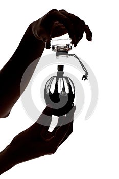 Female hands holding a perfume bottle
