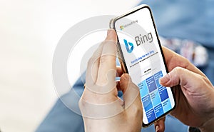 Female hands holding a phone with the Microsoft Bing website on the screen