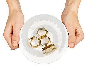 Female hands holding plate with screwnuts