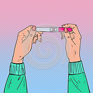 Female Hands Holding Positive Pregnancy Test with Two Red Stripes
