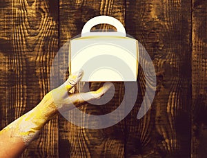 Female hands holding present on brown vintage studio background