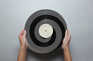 Female hands holding a retro vinyl record