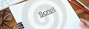 Female hands holding script over table closeup
