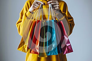 Female hands holding and showing colorful shopping bags