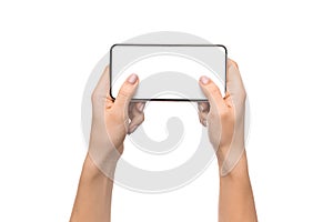 Female hands holding smartphone with blank screen, playing video games