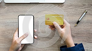 female hands holding a smartphone white screen mockup. online payment, mobile banking, online shopping