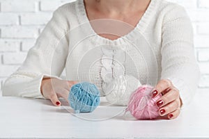 Female hands holding stitching, yarn, thread close up. materials for handmade and handiwork