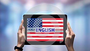Female hands holding tablet with English word against USA flag, online app