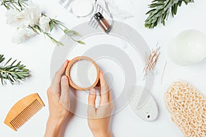 Female hands holding wooden bowl with sea bath salt