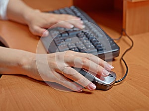 Female hands at keyboard and mouse