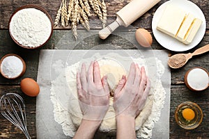 Female hands knead dough