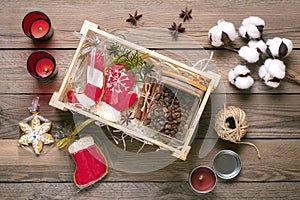 female hands laid care package, seasonal gift box with coffee, gingerbread and cinnamon Personalized eco friendly basket for