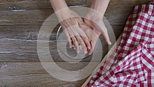 Female hands lay out pieces of onion in a glass bowl