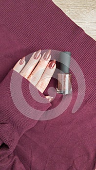 Female hands with long nails with brown nail polish