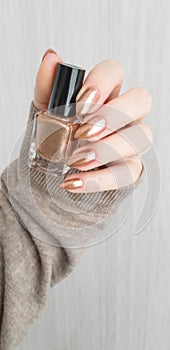 Female hands with long nails with brown nail polish