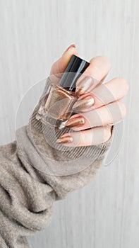 Female hands with long nails with brown nail polish