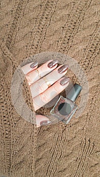 Female hands with long nails with brown nail polish