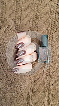 Female hands with long nails with brown nail polish