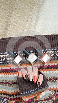 Female hands with long nails with brown nail polish