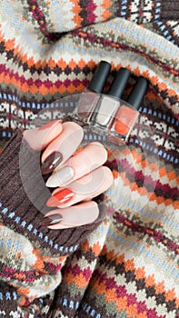 Female hands with long nails with brown nail polish