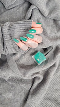 Female hands with long nails with green nail polish