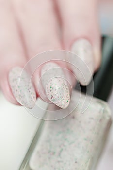 female hands with long nails light pastel manicure