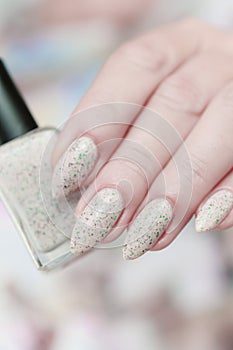 female hands with long nails light pastel manicure