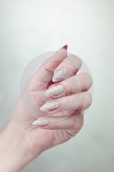 female hands with long nails light pastel manicure