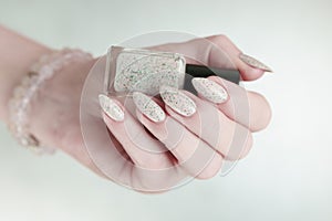 female hands with long nails light pastel manicure