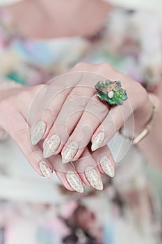 female hands with long nails light pastel manicure