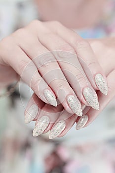 female hands with long nails light pastel manicure