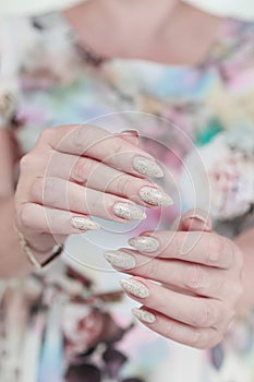 female hands with long nails light pastel manicure