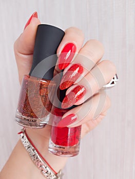 Female hands with long nails with red nail polish