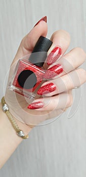 Female hands with long nails with red nail polish