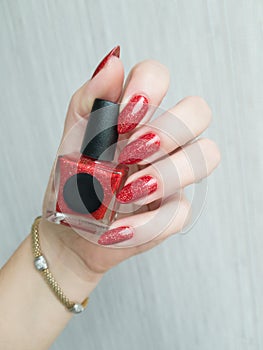 Female hands with long nails with red nail polish