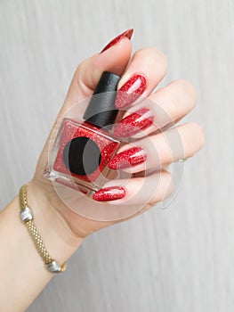 Female hands with long nails with red nail polish