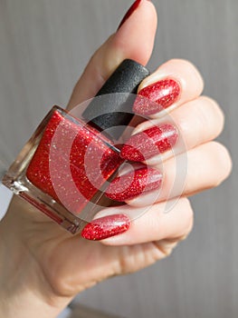 Female hands with long nails with red nail polish