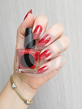 Female hands with long nails with red nail polish